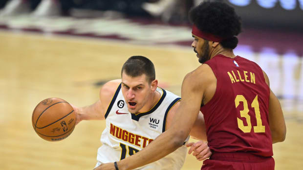 Feb 23, 2023; Cleveland, Ohio, USA; Denver Nuggets center Nikola Jokic (15) fights for position against Cavaliers center Jarrett Allen (31) in the first quarter at Rocket Mortgage FieldHouse. Mandatory Credit: David Richard-USA TODAY Sports
